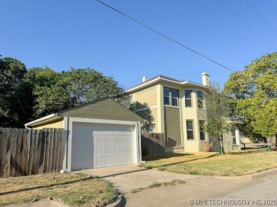 121 F SW, Ardmore, OK 73401 - view of front of home with an outbuilding, a detached garage, and driveway