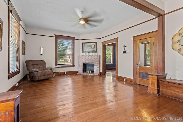 121 F SW, Ardmore, OK 73401 - living room featuring wood finished floors, a fireplace, and a ceiling fan
