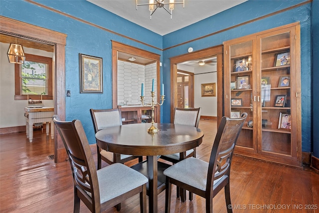 121 F SW, Ardmore, OK 73401 - dining room featuring wood finished floors, a textured wall, and a chandelier