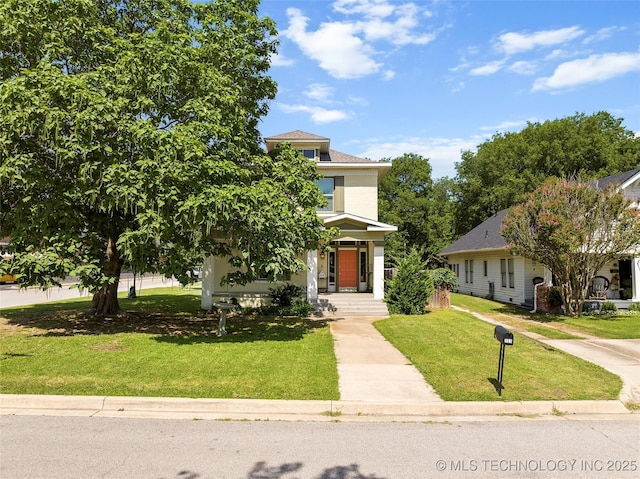 121 F SW, Ardmore, OK 73401 - american foursquare style home featuring stucco siding, a front yard, and covered porch