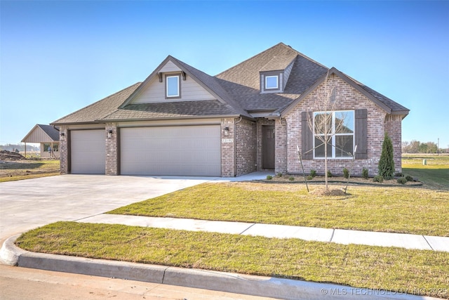 23192 E 106th St S, Broken Arrow, OK 74014 - view of front facade featuring a garage, brick siding, a front lawn, roof with shingles, and driveway