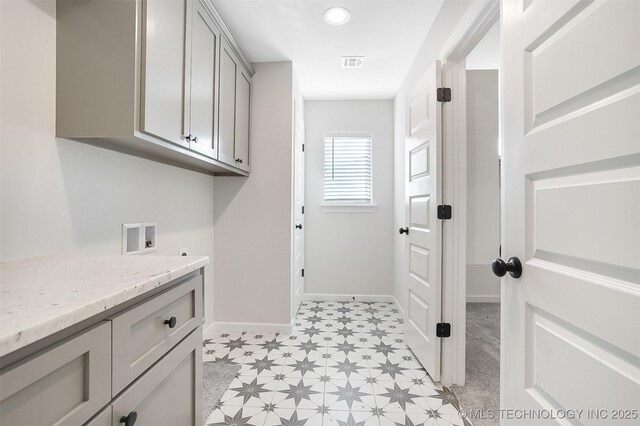23192 E 106th St S, Broken Arrow, OK 74014 - clothes washing area featuring washer hookup, light floors, baseboards, visible vents, and cabinet space