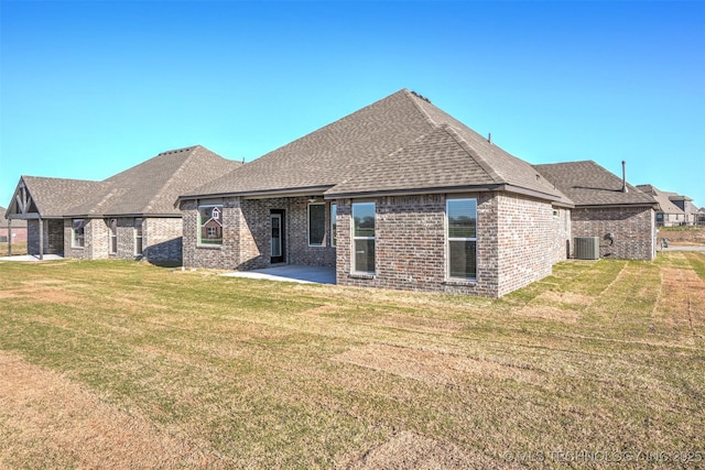 23192 E 106th St S, Broken Arrow, OK 74014 - rear view of property featuring a patio, central AC, brick siding, a shingled roof, and a yard