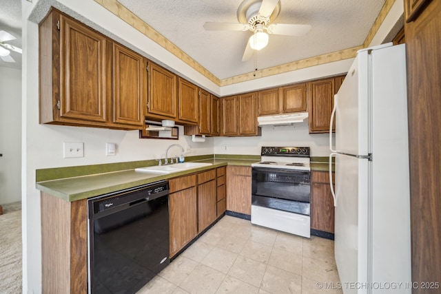 kitchen with black dishwasher, under cabinet range hood, range with electric cooktop, a sink, and freestanding refrigerator
