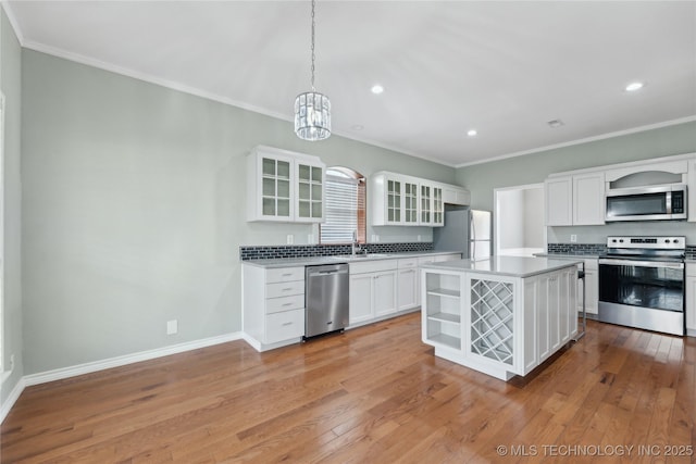 kitchen featuring crown molding, open shelves, recessed lighting, a chandelier, and stainless steel appliances