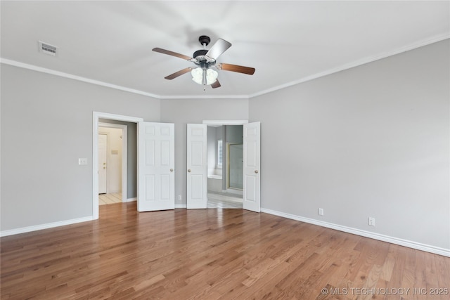 interior space featuring baseboards, visible vents, and wood finished floors