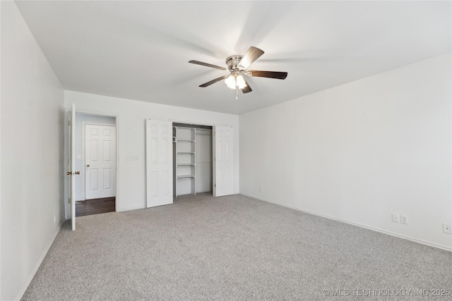 unfurnished bedroom featuring baseboards, carpet, and a closet