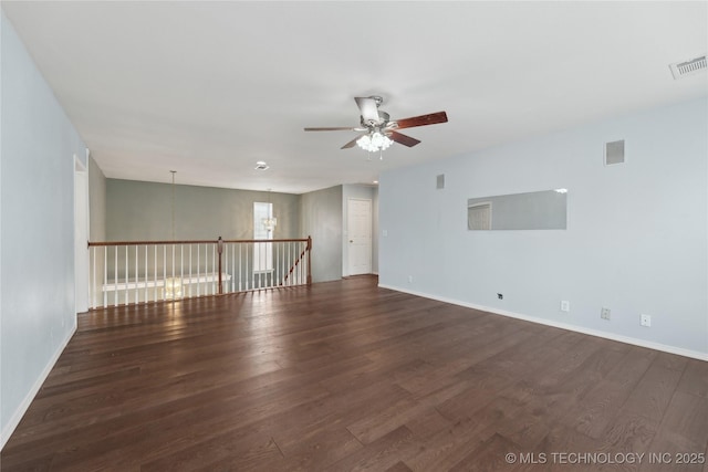 unfurnished room with visible vents, baseboards, ceiling fan, and wood finished floors