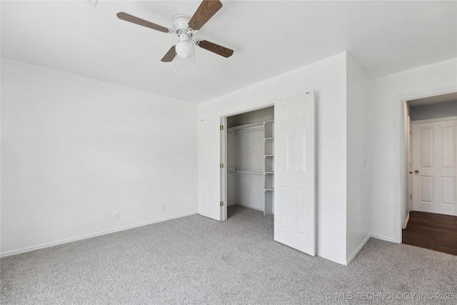 unfurnished bedroom with baseboards, ceiling fan, carpet, and a closet