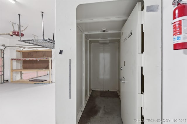 corridor with unfinished concrete flooring