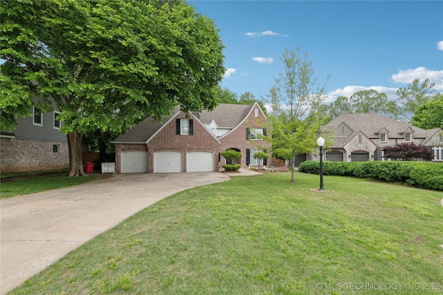view of front of property with concrete driveway, brick siding, an attached garage, and a front lawn