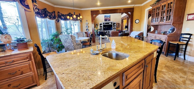 23280 E Horseshoe Bend Rd, Park Hill, OK 74451 - kitchen featuring an island with sink, crown molding, light stone counters, glass insert cabinets, and arched walkways