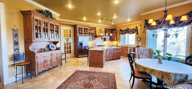 23280 E Horseshoe Bend Rd, Park Hill, OK 74451 - kitchen with stainless steel fridge, brown cabinetry, an island with sink, a chandelier, and tasteful backsplash