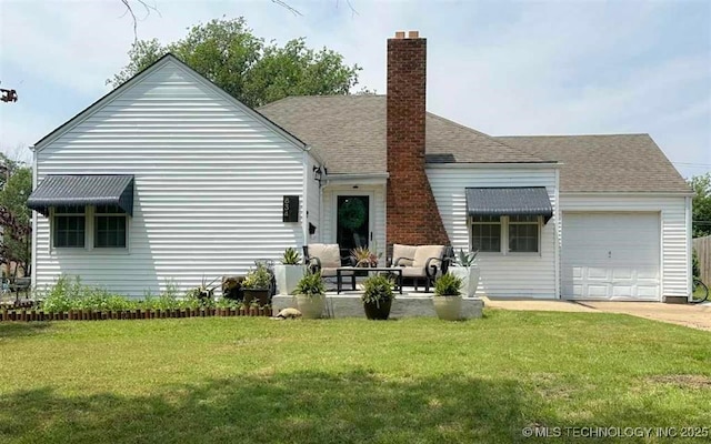 rear view of house featuring an outdoor living space, a chimney, an attached garage, and a yard