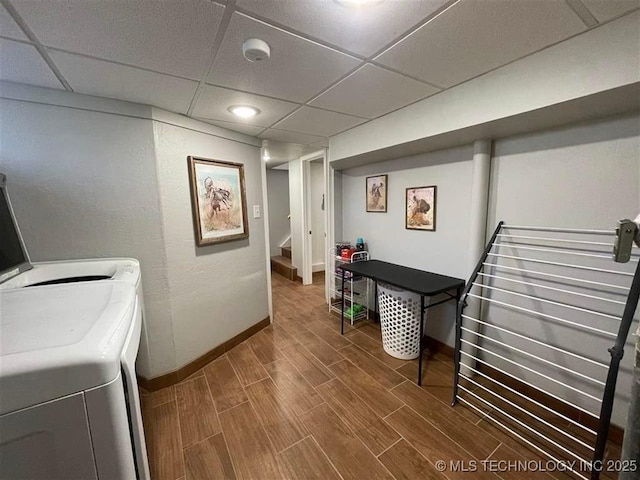 washroom featuring baseboards, wood tiled floor, independent washer and dryer, and laundry area