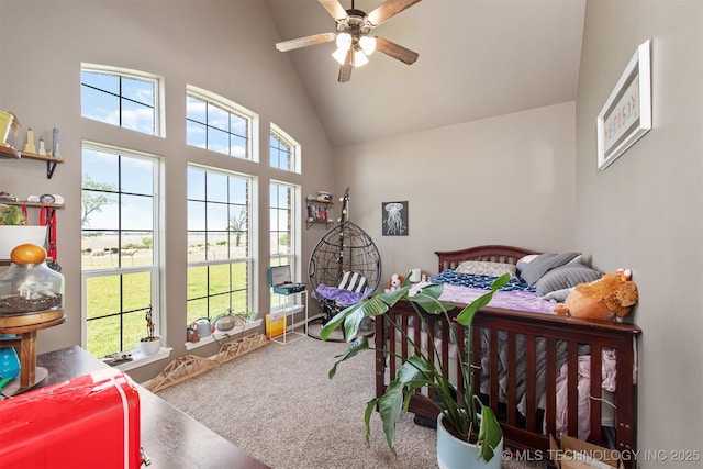 carpeted bedroom featuring a ceiling fan and high vaulted ceiling