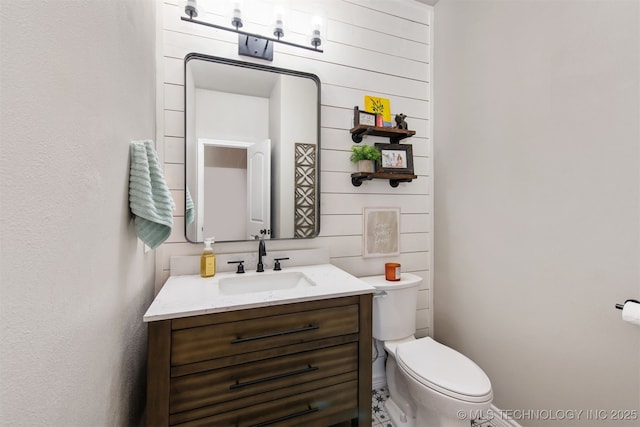 bathroom with toilet and vanity
