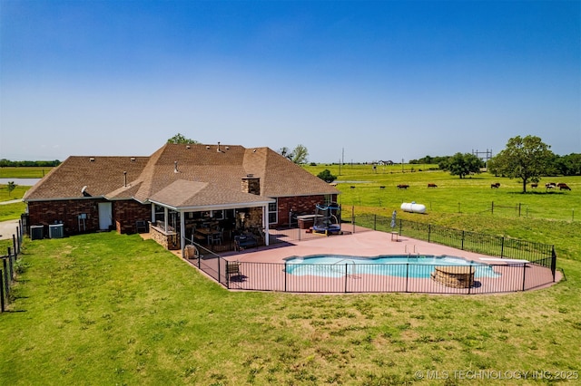 view of swimming pool with a yard, fence, a patio area, and a fenced in pool