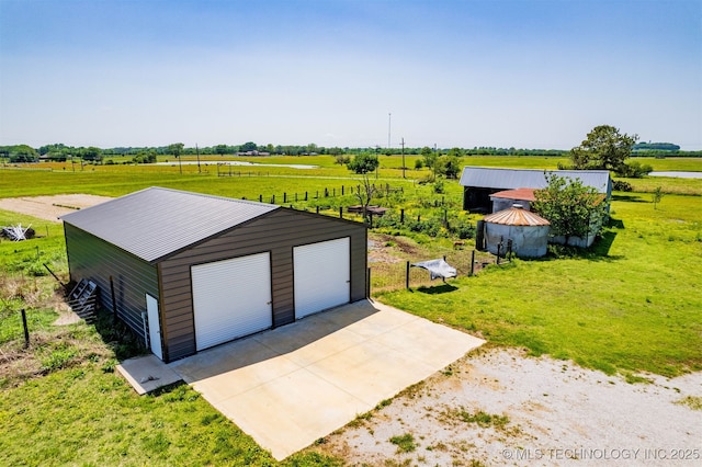 detached garage featuring a rural view