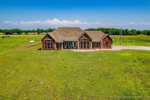 view of front of property with fence, french doors, and a front lawn