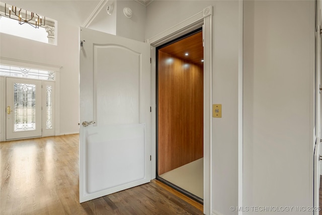 8315 N 99th E Ave, Owasso, OK 74055 - corridor with wood finished floors and a chandelier
