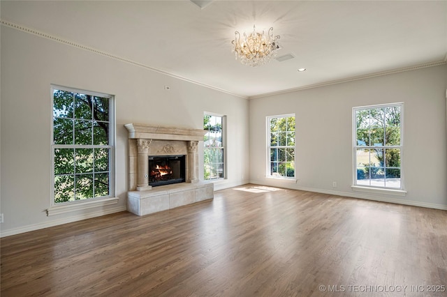8315 N 99th E Ave, Owasso, OK 74055 - unfurnished living room featuring a chandelier, wood finished floors, a tile fireplace, ornamental molding, and recessed lighting