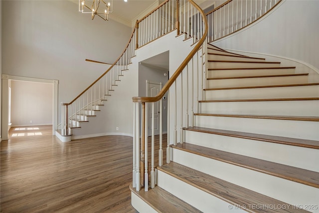 8315 N 99th E Ave, Owasso, OK 74055 - stairway featuring a towering ceiling, wood finished floors, and a chandelier