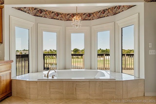 8315 N 99th E Ave, Owasso, OK 74055 - bathroom featuring healthy amount of natural light, a bath, tile patterned flooring, and a chandelier