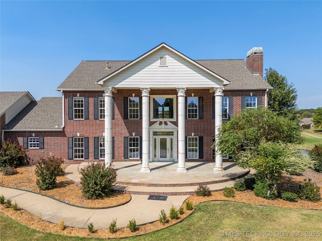 8315 N 99th E Ave, Owasso, OK 74055 - neoclassical / greek revival house with brick siding, a chimney, and a shingled roof