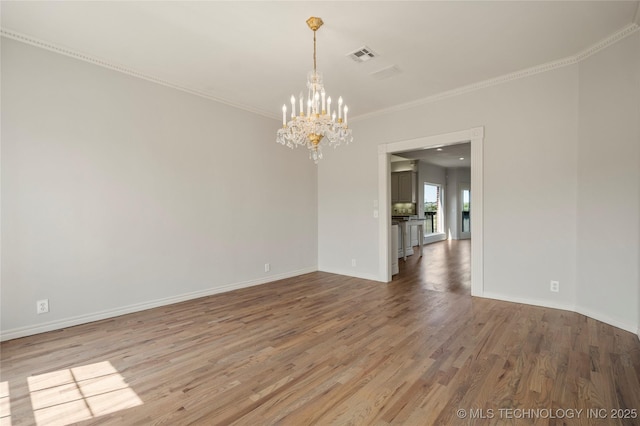 8315 N 99th E Ave, Owasso, OK 74055 - spare room with a chandelier, wood finished floors, and ornamental molding