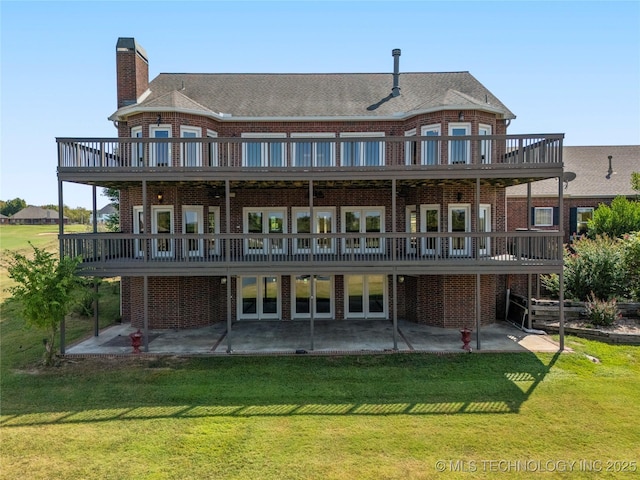 8315 N 99th E Ave, Owasso, OK 74055 - back of property featuring brick siding, a patio, and a lawn