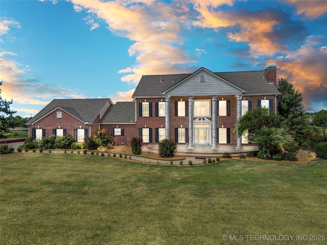 8315 N 99th E Ave, Owasso, OK 74055 - greek revival inspired property featuring brick siding, a chimney, and a lawn
