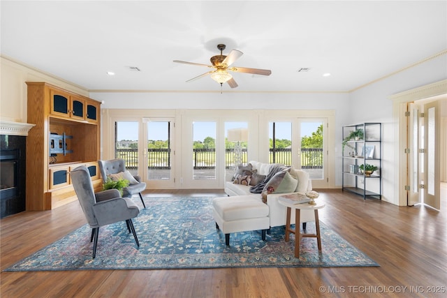 8315 N 99th E Ave, Owasso, OK 74055 - living area with healthy amount of natural light, a premium fireplace, ceiling fan, crown molding, and wood finished floors
