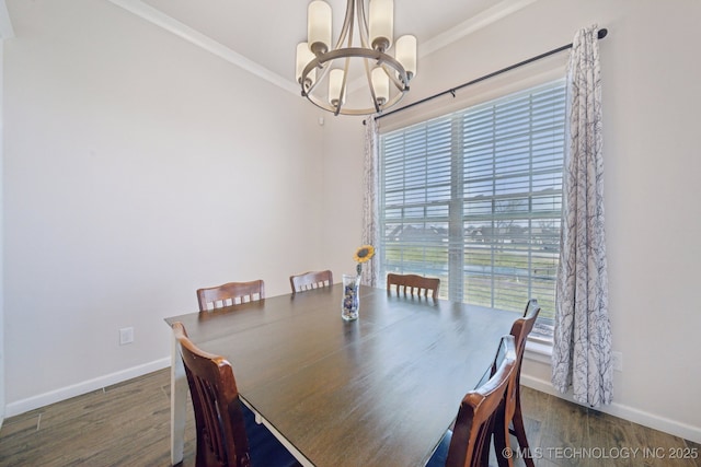 dining area with an inviting chandelier, wood finished floors, crown molding, and baseboards