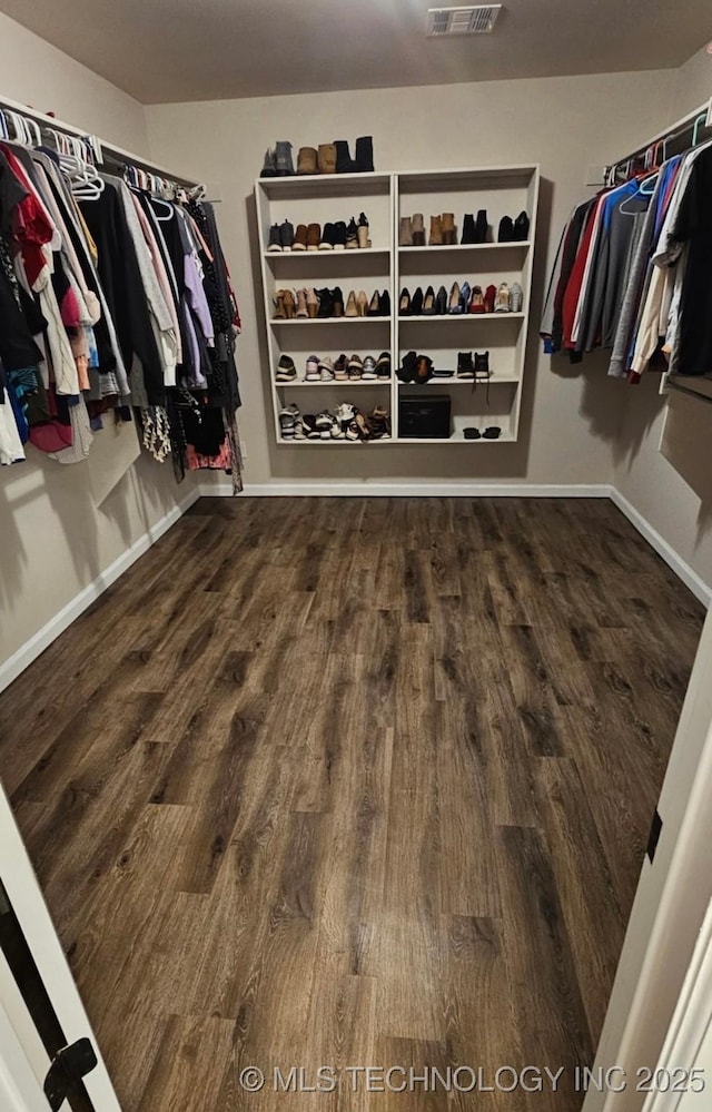 walk in closet with visible vents and wood finished floors