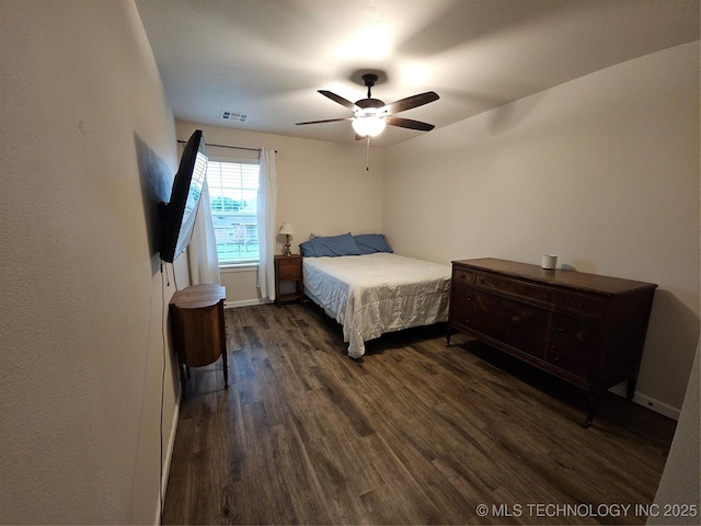 bedroom featuring visible vents, ceiling fan, and dark wood-style flooring