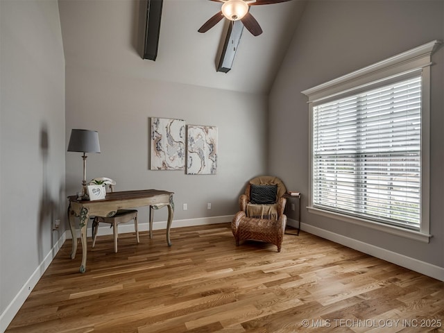 living area with baseboards, lofted ceiling, light wood-style floors, and a ceiling fan