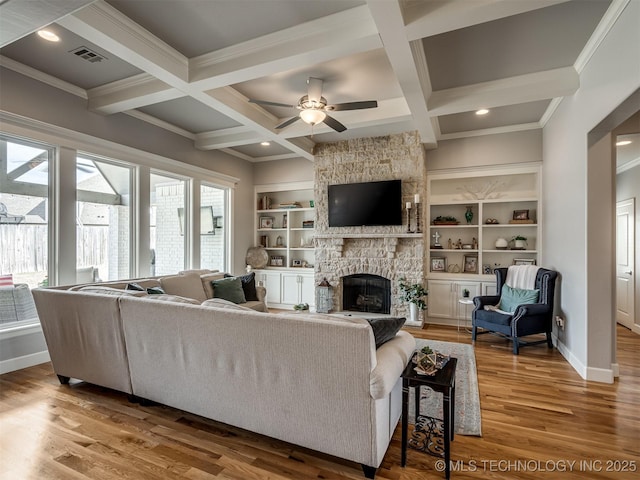 living area featuring a ceiling fan, wood finished floors, coffered ceiling, and visible vents