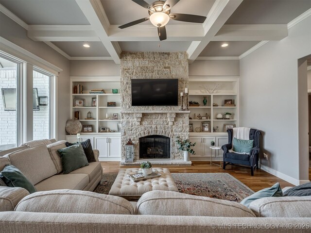 living room featuring a fireplace, ceiling fan, wood finished floors, and coffered ceiling