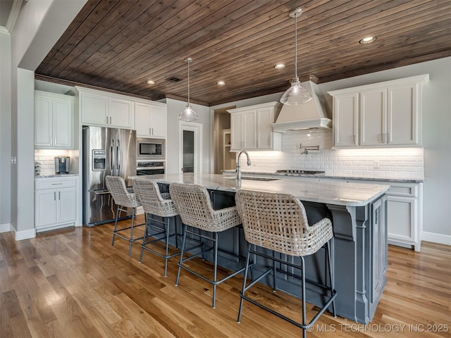 kitchen featuring white cabinetry, light wood-style flooring, a sink, and stainless steel appliances