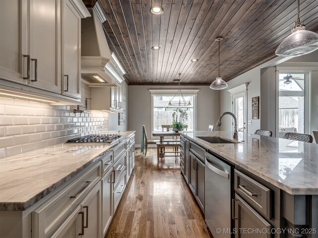 5519 E 123rd St S, Bixby, OK 74008 - kitchen featuring appliances with stainless steel finishes, a sink, wood ceiling, a kitchen island with sink, and wood finished floors