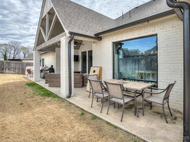 view of patio with a ceiling fan, outdoor dining area, an outdoor living space, and fence