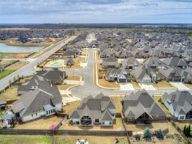birds eye view of property featuring a residential view and a water view