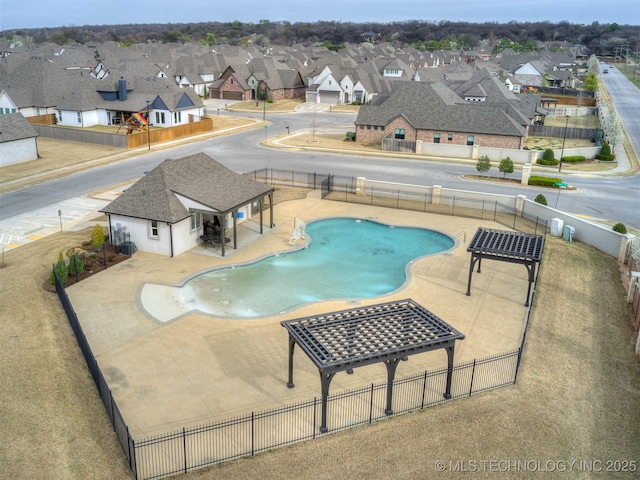 community pool featuring a fenced backyard, a residential view, central air condition unit, and a patio area