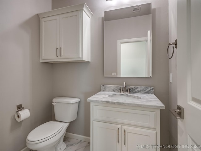 bathroom featuring toilet, vanity, marble finish floor, baseboards, and visible vents