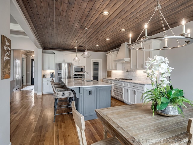 5519 E 123rd St S, Bixby, OK 74008 - kitchen featuring stainless steel appliances, white cabinets, a sink, premium range hood, and crown molding