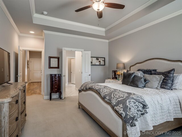 bedroom featuring light colored carpet, crown molding, a ceiling fan, and a raised ceiling