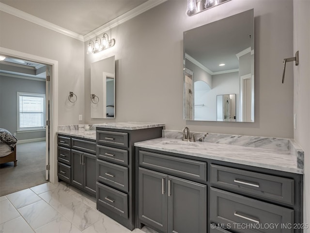 bathroom featuring marble finish floor, crown molding, and vanity
