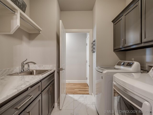 5519 E 123rd St S, Bixby, OK 74008 - laundry room featuring cabinet space, light marble finish flooring, washing machine and clothes dryer, and baseboards
