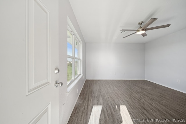 interior space with baseboards, ceiling fan, and wood finished floors
